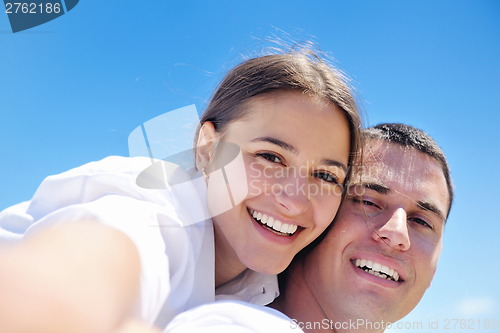 Image of happy couple have fun on the beach