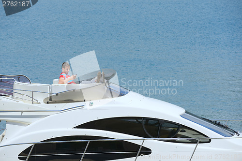 Image of young man on yacht