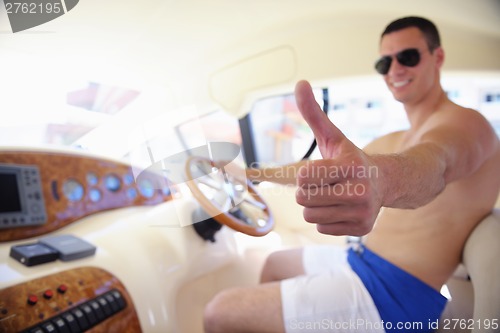 Image of young man on yacht