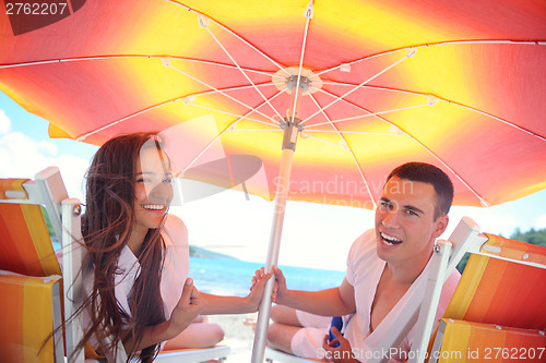 Image of happy couple have fun on the beach