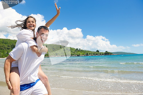 Image of happy couple have fun on the beach