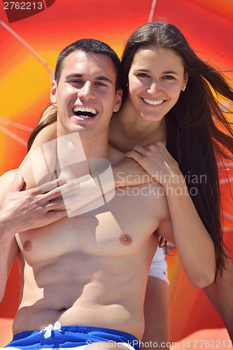 Image of happy couple have fun on the beach