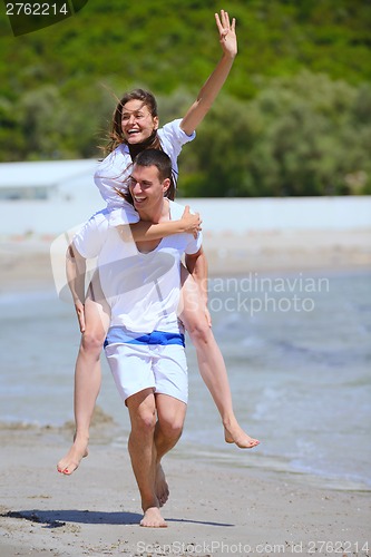 Image of happy couple have fun on the beach