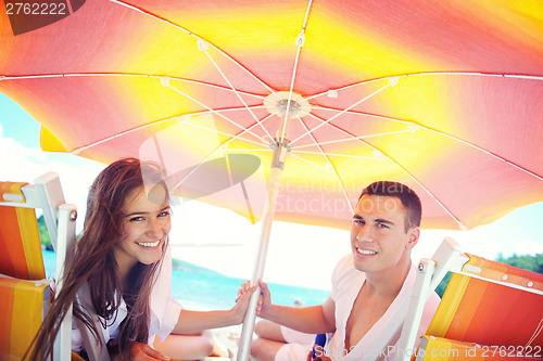 Image of happy couple have fun on the beach