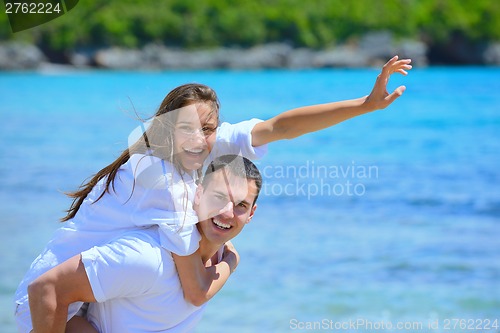 Image of happy couple have fun on the beach