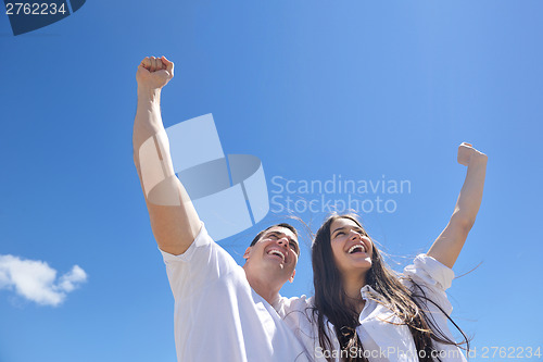 Image of happy couple have fun on the beach