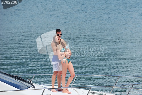 Image of young couple on yacht