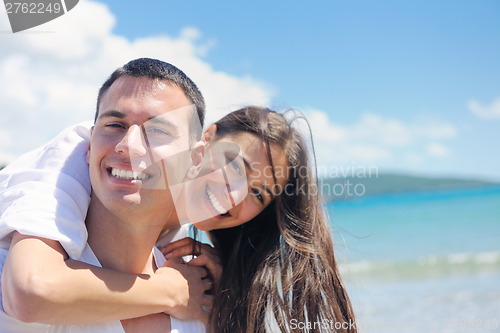 Image of happy couple have fun on the beach