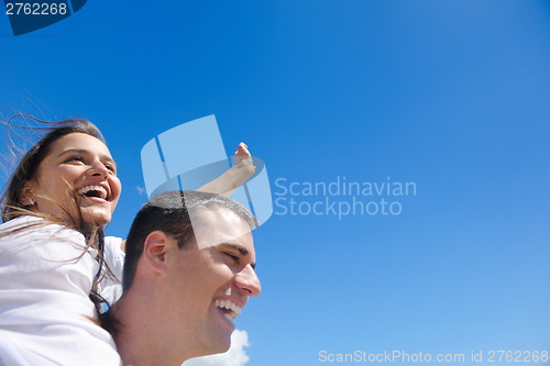 Image of happy couple have fun on the beach