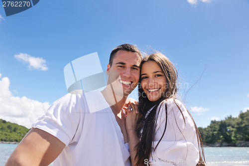 Image of happy couple have fun on the beach