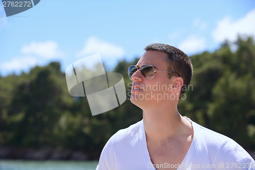 Image of young man on yacht