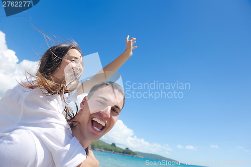 Image of happy couple have fun on the beach