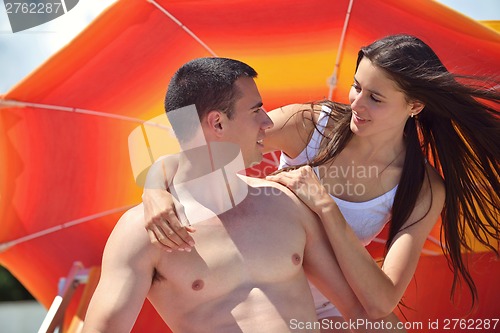 Image of happy couple have fun on the beach