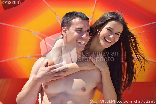 Image of happy couple have fun on the beach