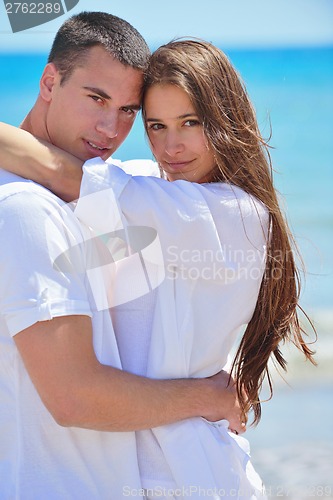 Image of happy couple have fun on the beach