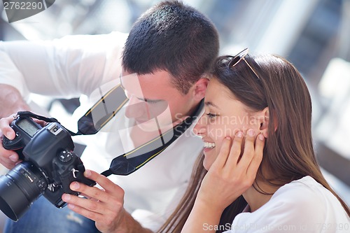 Image of couple looking photos on camera