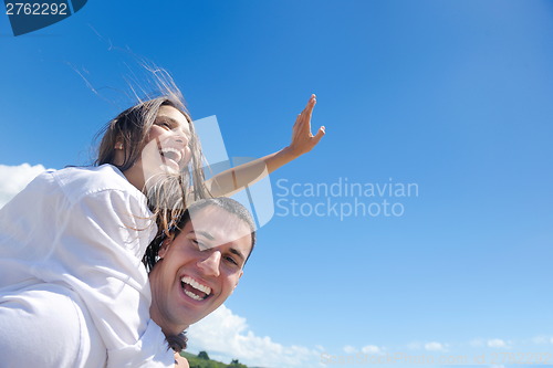 Image of happy couple have fun on the beach