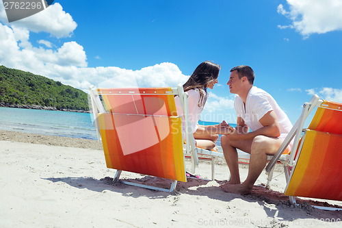 Image of happy couple have fun on the beach