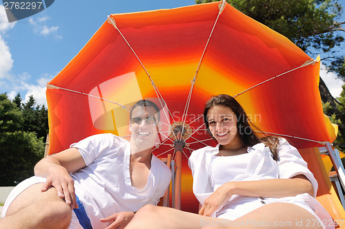 Image of happy couple have fun on the beach