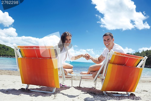 Image of happy couple have fun on the beach