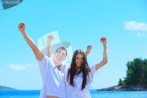 Image of happy couple have fun on the beach