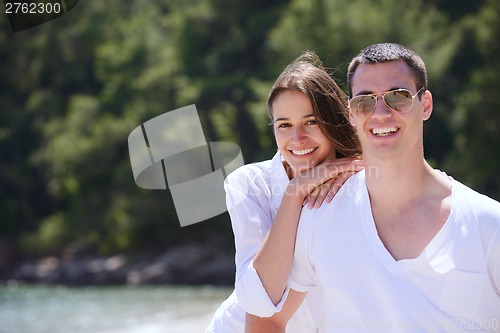 Image of happy couple have fun on the beach