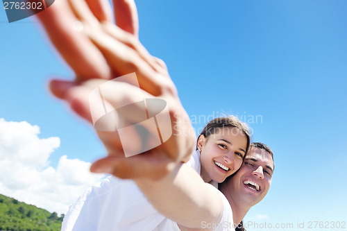 Image of happy couple have fun on the beach