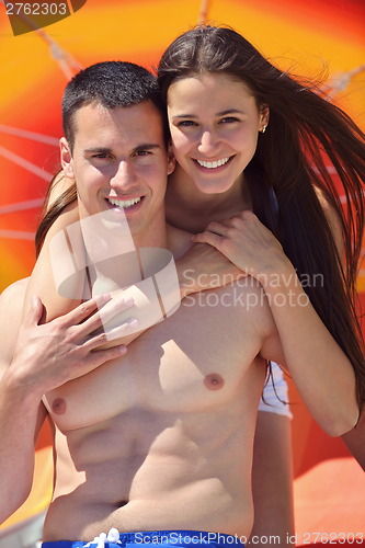 Image of happy couple have fun on the beach