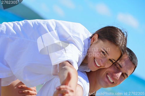 Image of happy couple have fun on the beach