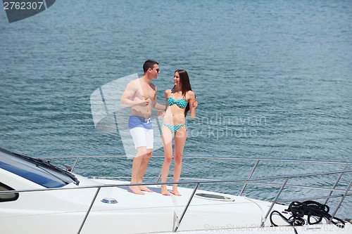 Image of young couple on yacht