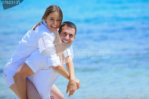 Image of happy couple have fun on the beach