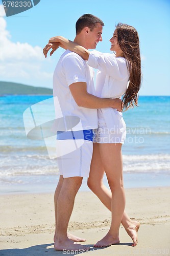 Image of happy couple have fun on the beach