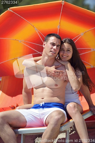 Image of happy couple have fun on the beach