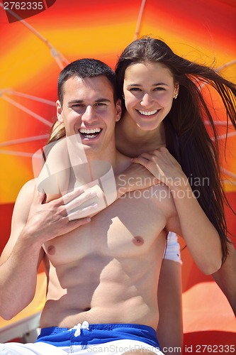 Image of happy couple have fun on the beach