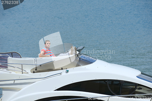 Image of young man on yacht