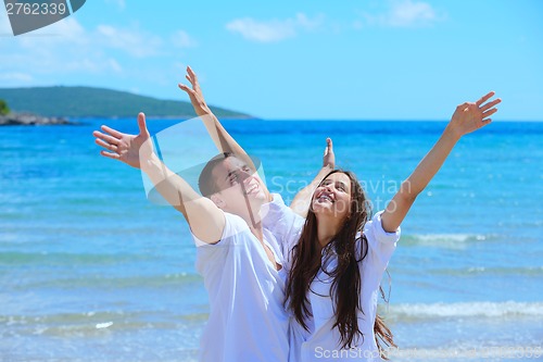 Image of happy couple have fun on the beach