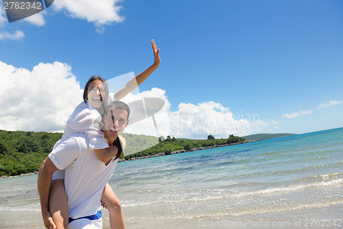 Image of happy couple have fun on the beach