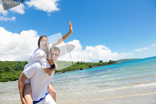 Image of happy couple have fun on the beach