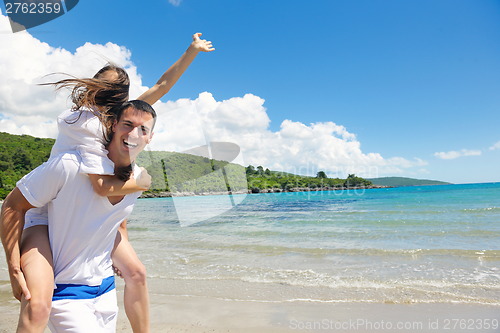 Image of happy couple have fun on the beach
