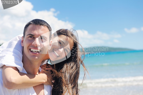 Image of happy couple have fun on the beach