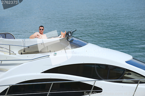 Image of young man on yacht