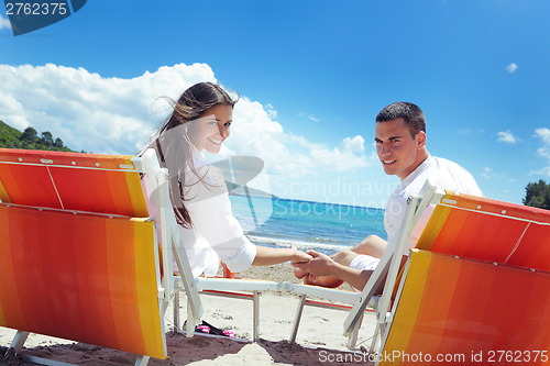 Image of happy couple have fun on the beach