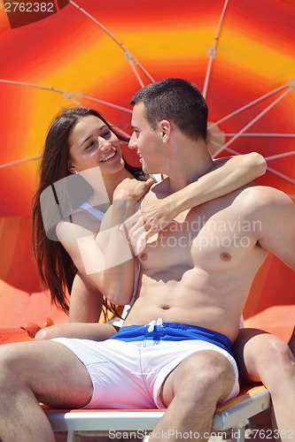 Image of happy couple have fun on the beach