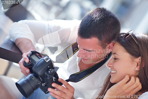 Image of couple looking photos on camera