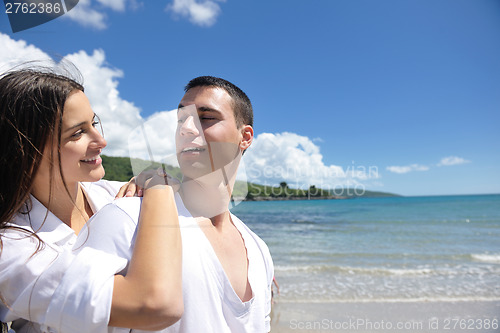 Image of happy couple have fun on the beach