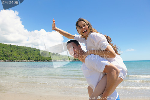 Image of happy couple have fun on the beach