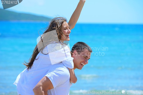 Image of happy couple have fun on the beach