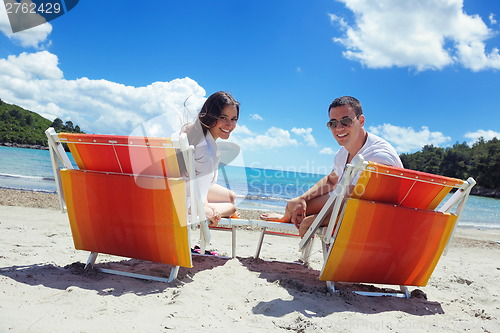 Image of happy couple have fun on the beach