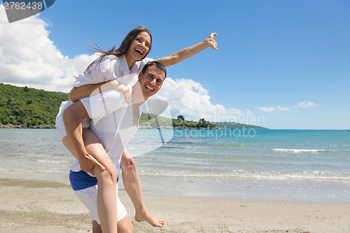 Image of happy couple have fun on the beach