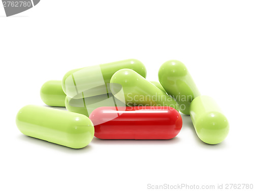 Image of Red and green pills on white